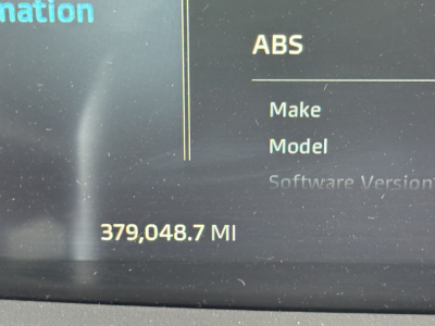 Dashboard display showing 379,048.7 MI with ABS in the top right and Make/Model labels faint. Vehicle information screen for a Kenworth truck.
