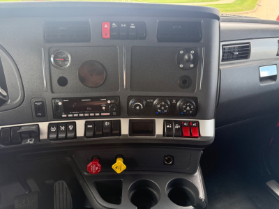 Dashboard of a Kenworth truck showing gauges, controls, and vents visible in the cab interior.