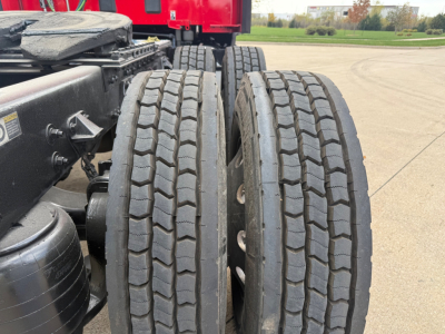 Kenworth T680 tractor chassis showing dual rear wheels and tire tread detail.