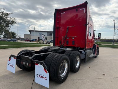 Kenworth T680 tractor in red cab, rear view showing sleeper, three axles, black chassis, mud flaps with MHC logo, VIN 1XKYD49X3PJ230266 not visible on image