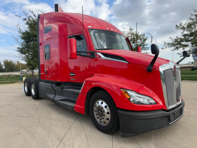 Kenworth T680 sleeper cab tractor in red, front-left view showing cab, chrome grille, large side mirrors, and dual rear axles.