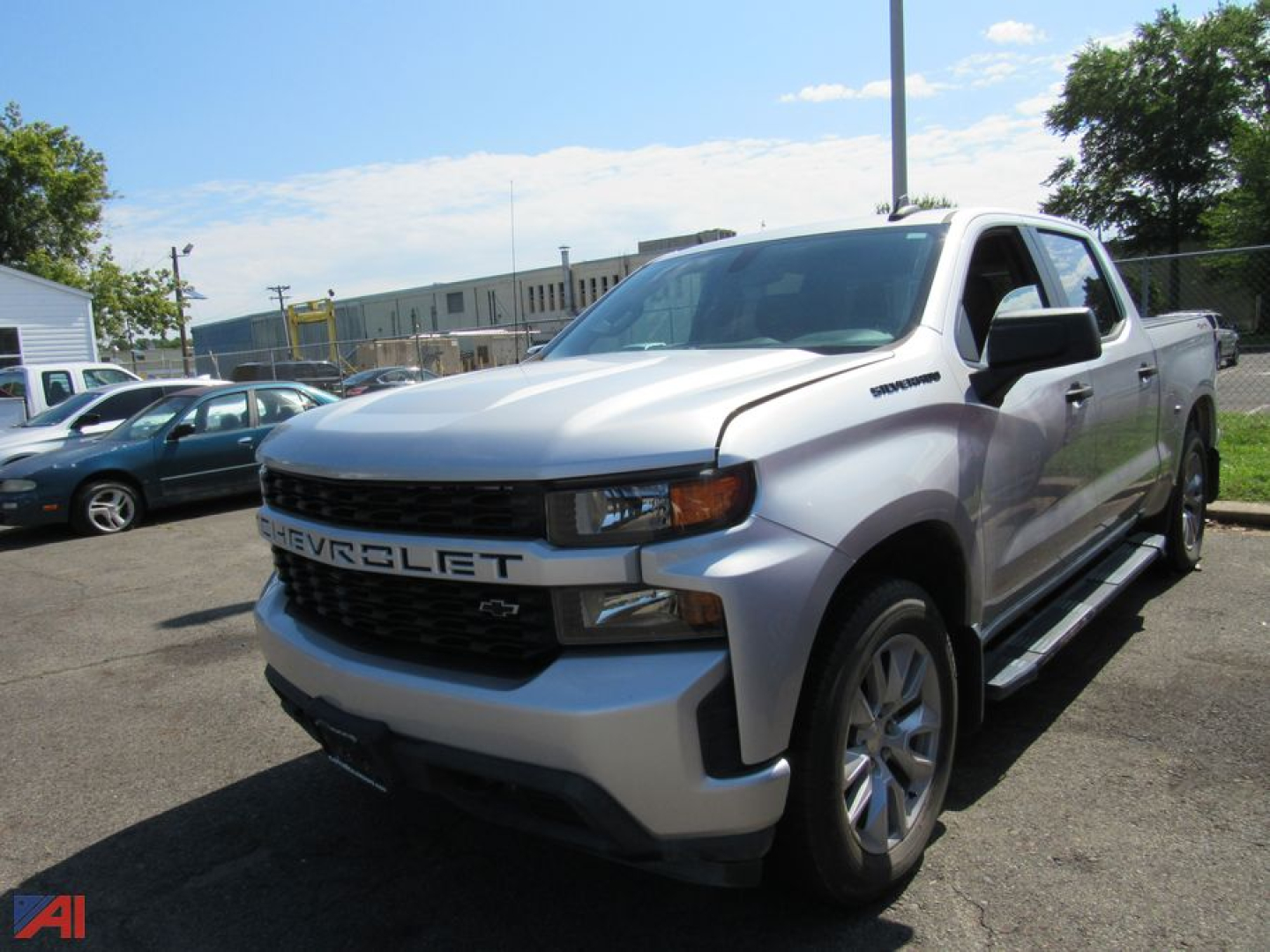 2022 Chevrolet Silverado 1500 Limited pickup truck in silver/gray with black grille, showing CHEVROLET lettering on grille and a crew cab, 4x4 badge on side.