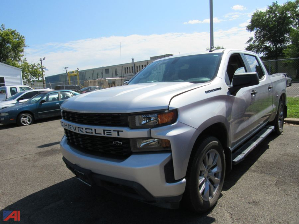2022 Chevrolet Silverado 1500 Limited pickup truck in silver/gray with black grille, showing CHEVROLET lettering on grille and a crew cab, 4x4 badge on side.