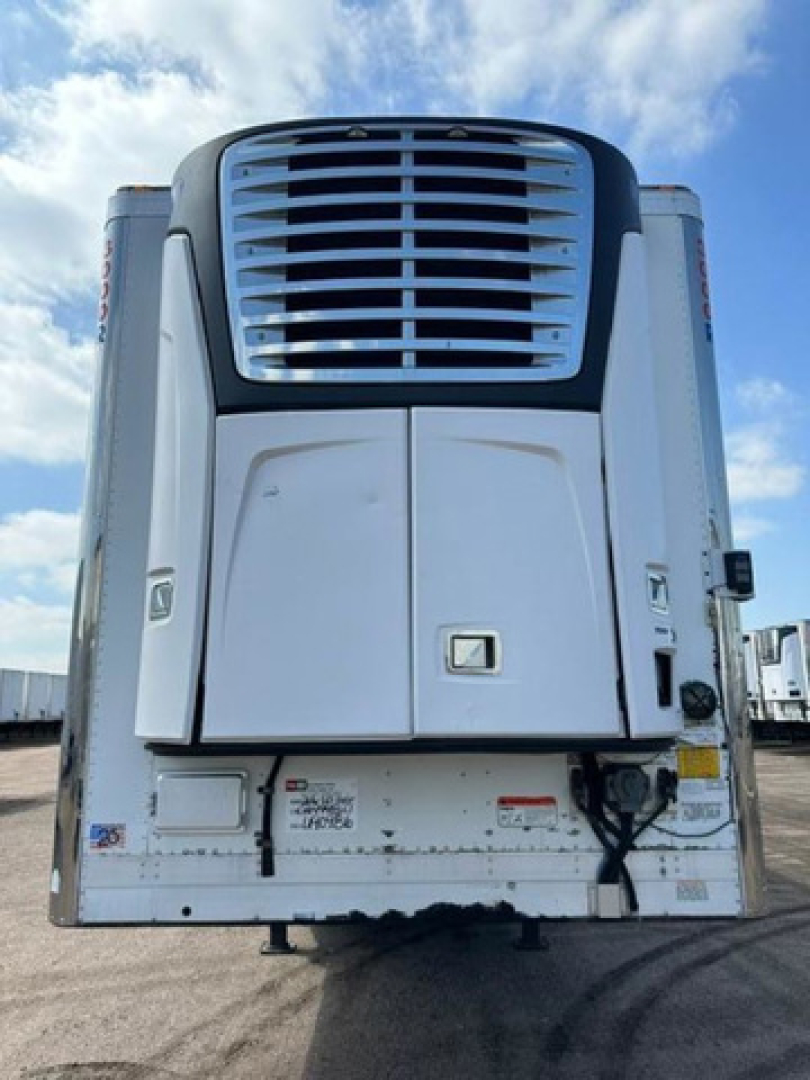Truck trailer rear view with large refrigeration unit and vents, white, with taillights on sides.
