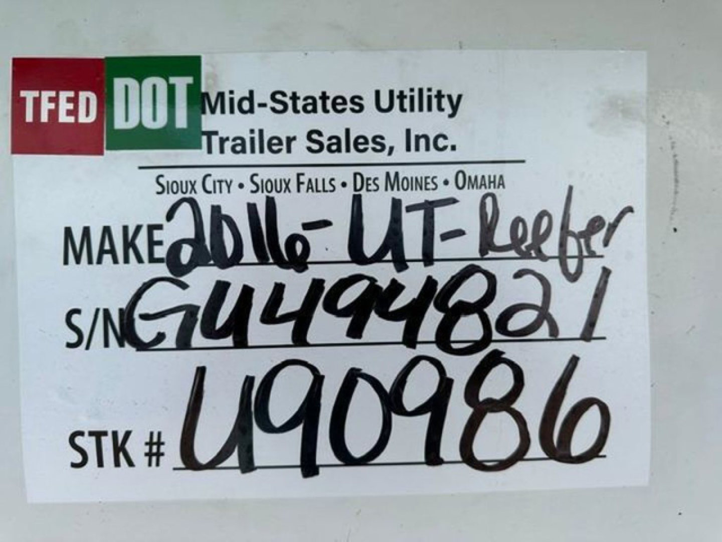 Trailer information sticker showing TFED DOT logo and handwritten stock number U90986 and S/N GU449481 with STK # U90986.