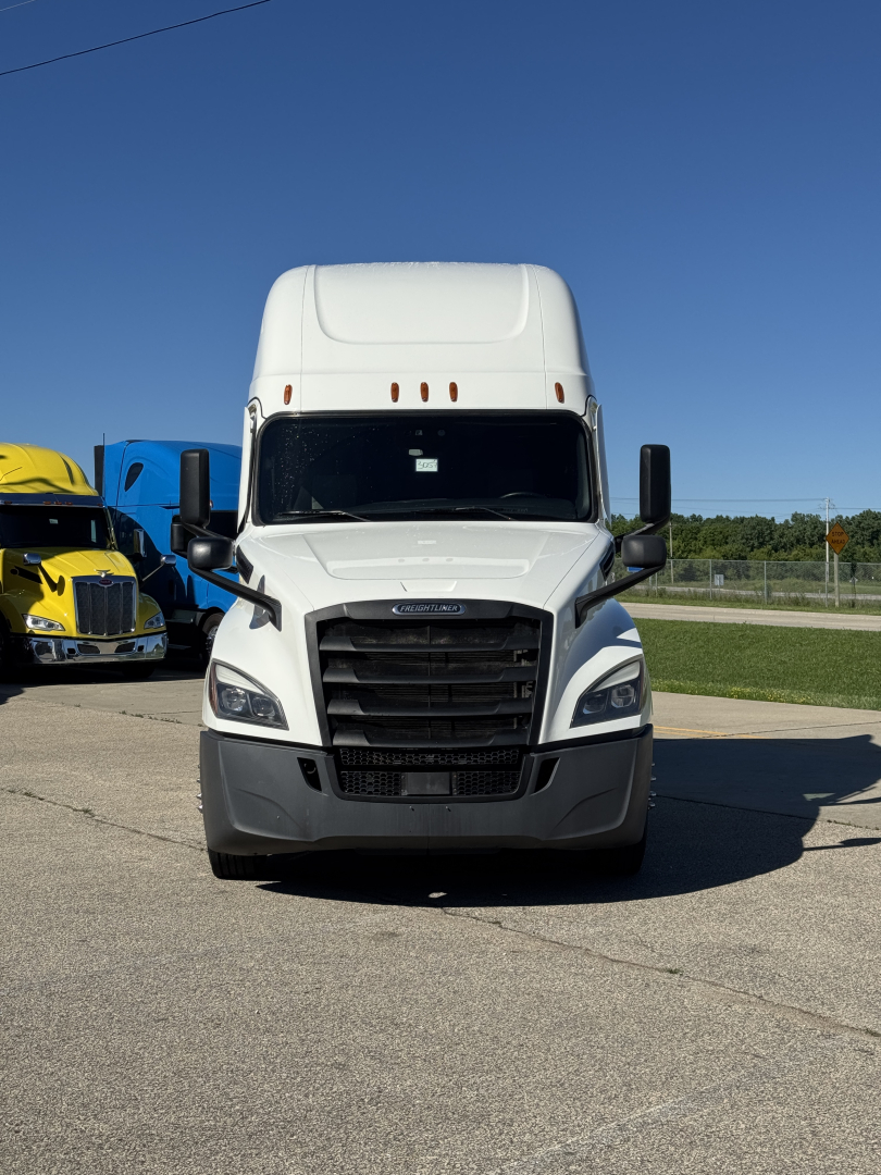 Freightliner Cascadia 126 front view showing large black grille, white cab, and streamlined headlights.