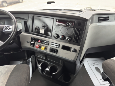 Cab interior of a Freightliner Cascadia 126 truck showing dashboard controls, steering wheel, and instrument panel.