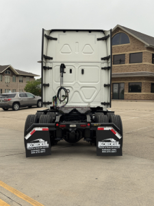 Rear view of a Freightliner Cascadia 126 tractor showing the back doors, wiring harness, and rear mud flaps with Kordel branding.