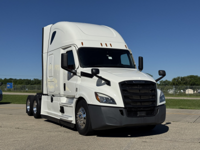 Freightliner Cascadia 126 conventional sleeper truck in white, front three-quarter view, showing cab, grille, headlights, and dual rear axles.