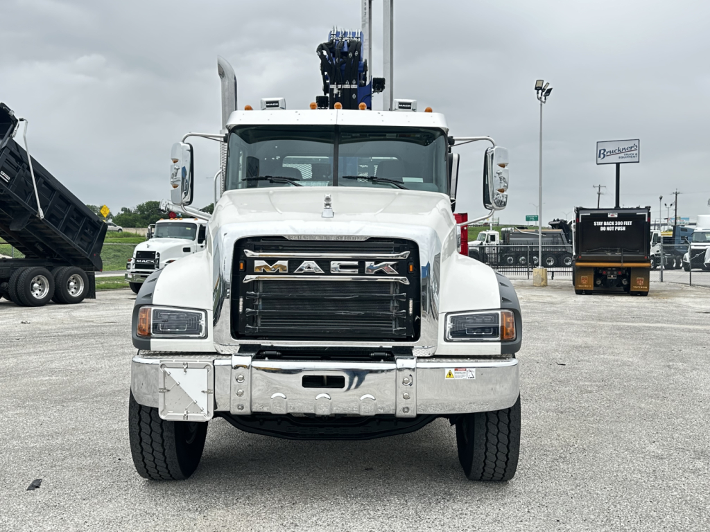 Front view of a white Mack GR64F cab and chassis truck with a large black grille and 'MACK' logo on the hood.