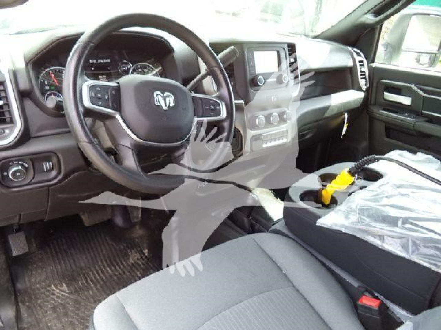 Ram truck interior showing steering wheel and dashboard with center console and gear area.