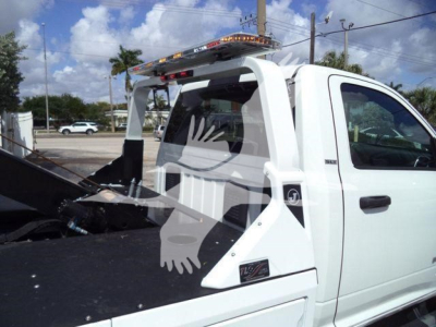 Ram 4500 SLT truck bed with winch setup and white cab, cargo bed equipment, roof light bar, side marker, and rear wheel well visible.
