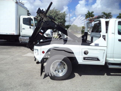 Ram 4500 SLT pickup truck with a mounted winch and crane in white, visible tire, Ram logo, and 'JERR-DY?' branding on side; no legible serials.