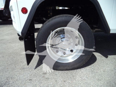 Truck wheel well and front tire with wheel rim visible; part of van/truck body around fender. No legible text or labels visible in the image.