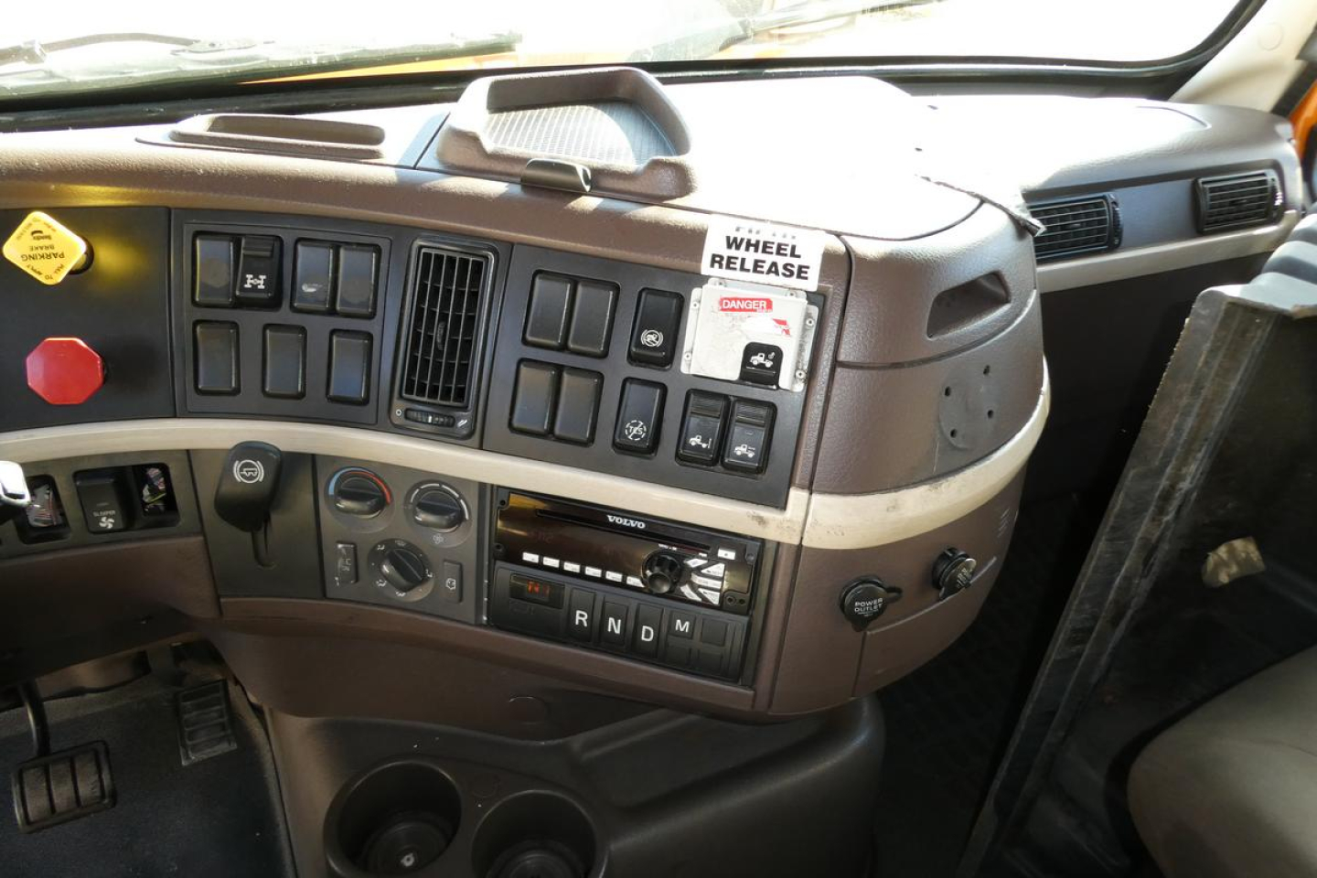 Volvo VNM truck cab interior showing dashboard switches and controls.