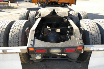 Back view of a Volvo VNM commercial tractor chassis with dual rear axles and fifth-wheel, showing tires and undercarriage components.