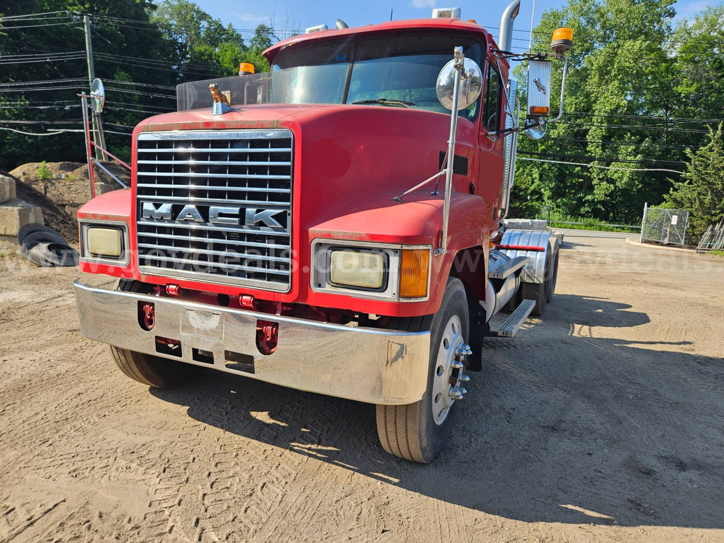 Truck front view showing red 2003 Mack CH613 with chrome grille, large bumper, dual headlights, and side mirrors. VIN/stock not visible in image.