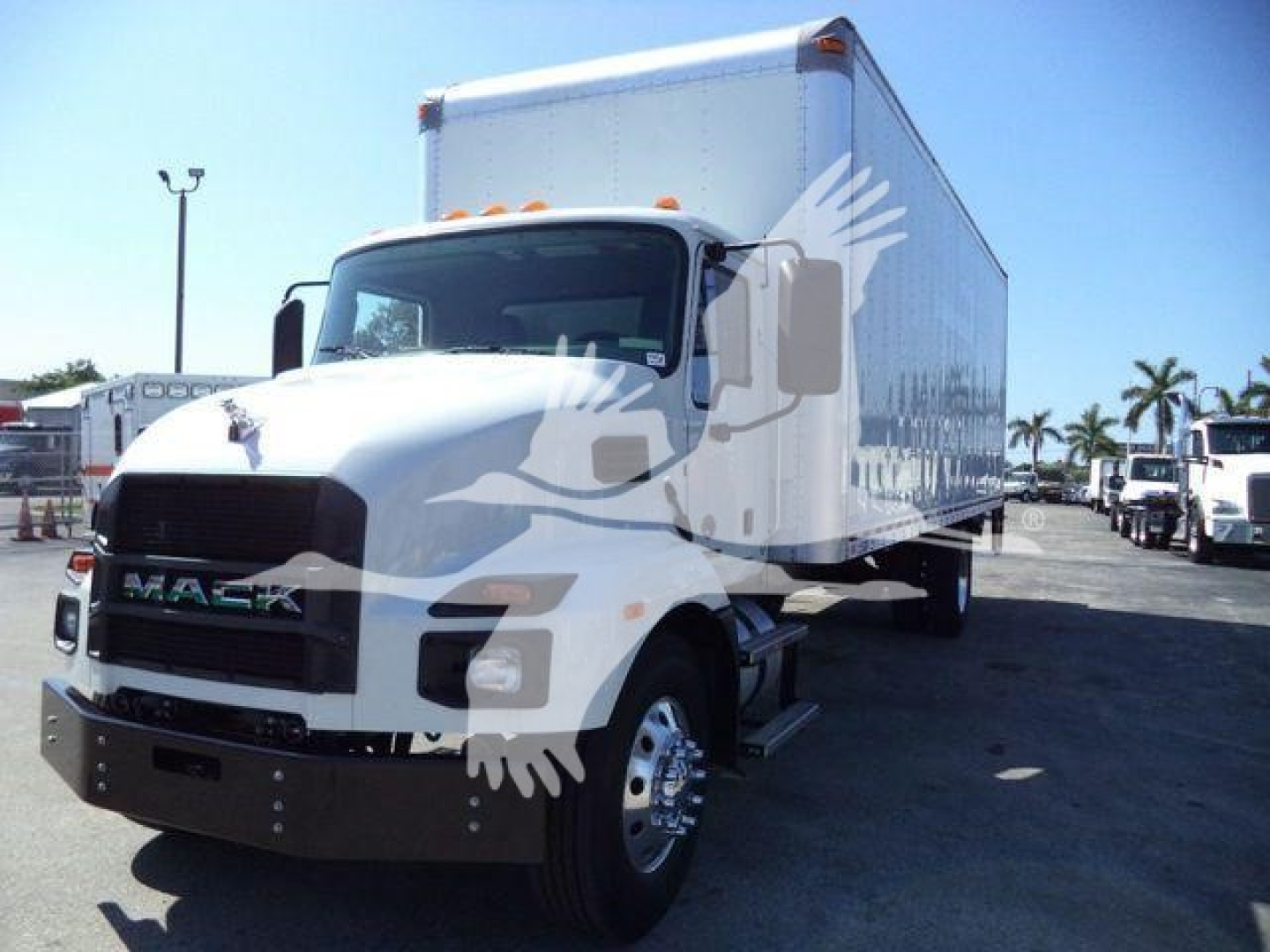 Truck in a dealership lot showing a white 2026 Mack MD6 box truck with cargo box and front bumper, MD6 branding on grille.