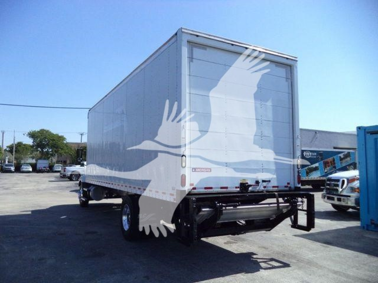 Box truck trailer rear view showing MD6 cargo box with logo watermark on white background, attached undercarriage and dual rear wheels.