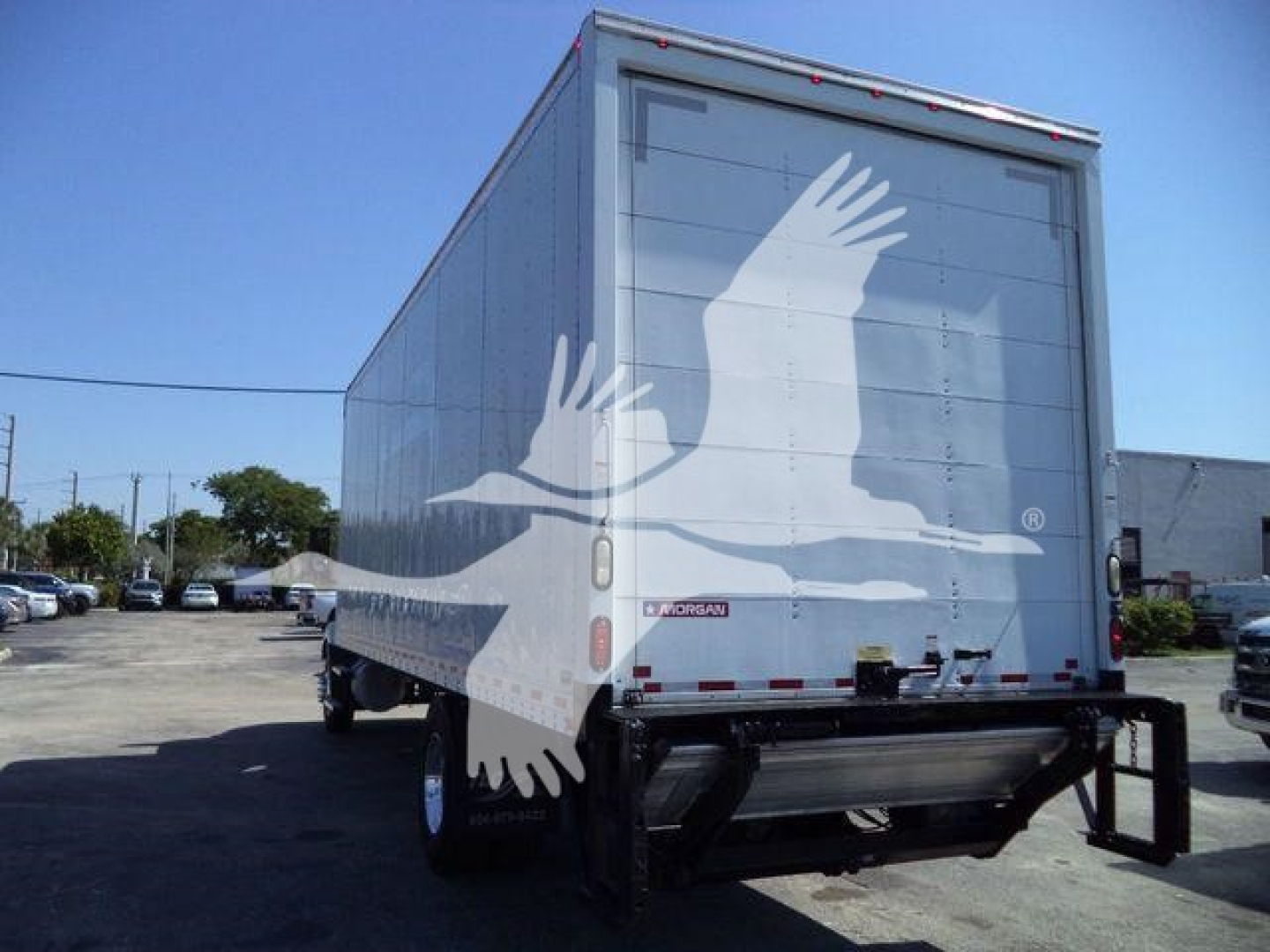 Box truck rear view showing Morgan box with white bird graphic and taillights.
