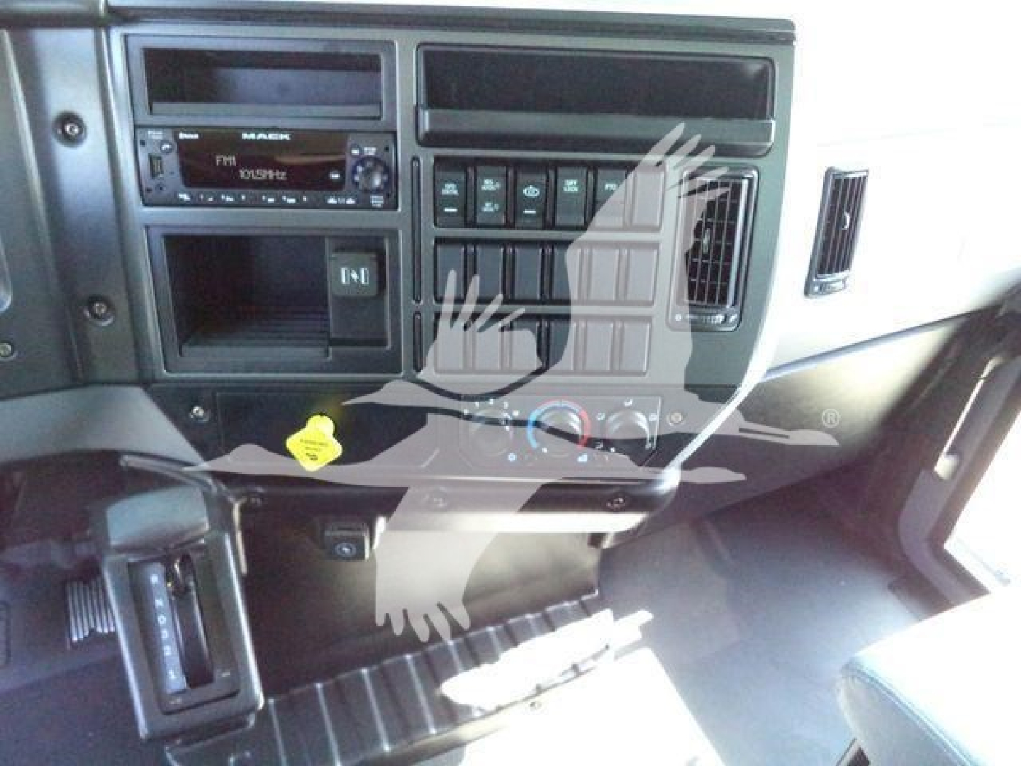 Mack MD6 truck dashboard with radio, climate controls, and various knobs visible.