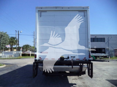 Rear view of a 2026 Mack MD6 box truck showing a white stylized eagle graphic on the back doors.