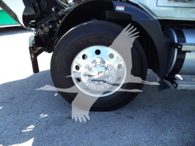Mack MD6 truck front wheel well showing chrome hub and black tire, with partial chassis components and fender visible.