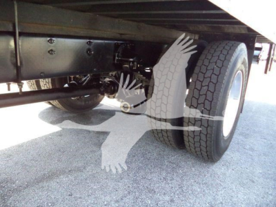 Underbody view of a new 2026 Mack MD6 box truck showing dual rear tires and chassis components.