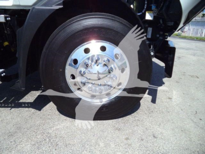 Wheel of a 2026 Mack MD6 truck showing chrome hub and tire with surrounding components