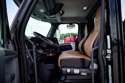 Truck cab interior of a 2027 Western Star 47X showing driver seat and front dashboard.