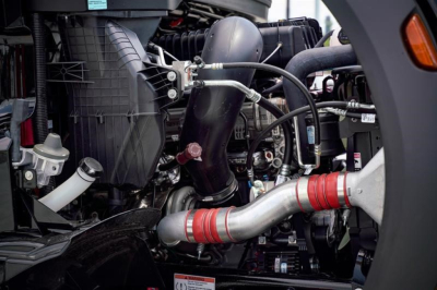 Western Star 47X engine bay showing hoses and metal piping with red silicone couplers.