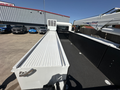 Truck bed of a new 2026 Mack MD7 service/utility truck showing aluminum cargo deck and side rails.