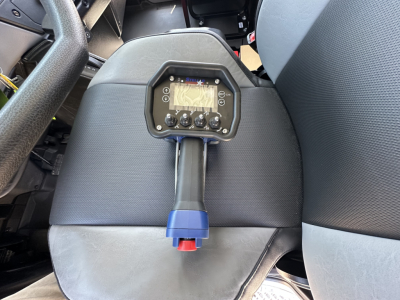 Mack MD7 vehicle interior with control panel mounted on a stalk between seats showing digital display and knobs.