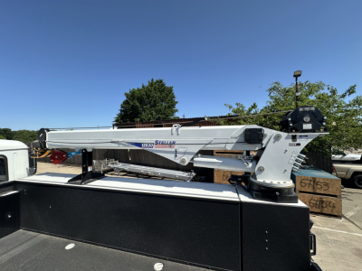 Mack MD7 utility crane mounted in truck bed showing Stellar crane branding and steel components.