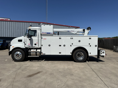 Service/Utility truck body shown in side view; white cab and utility/service compartments with multiple access doors; boomed equipment mounted on body; Mack MD7 likely badge on door.