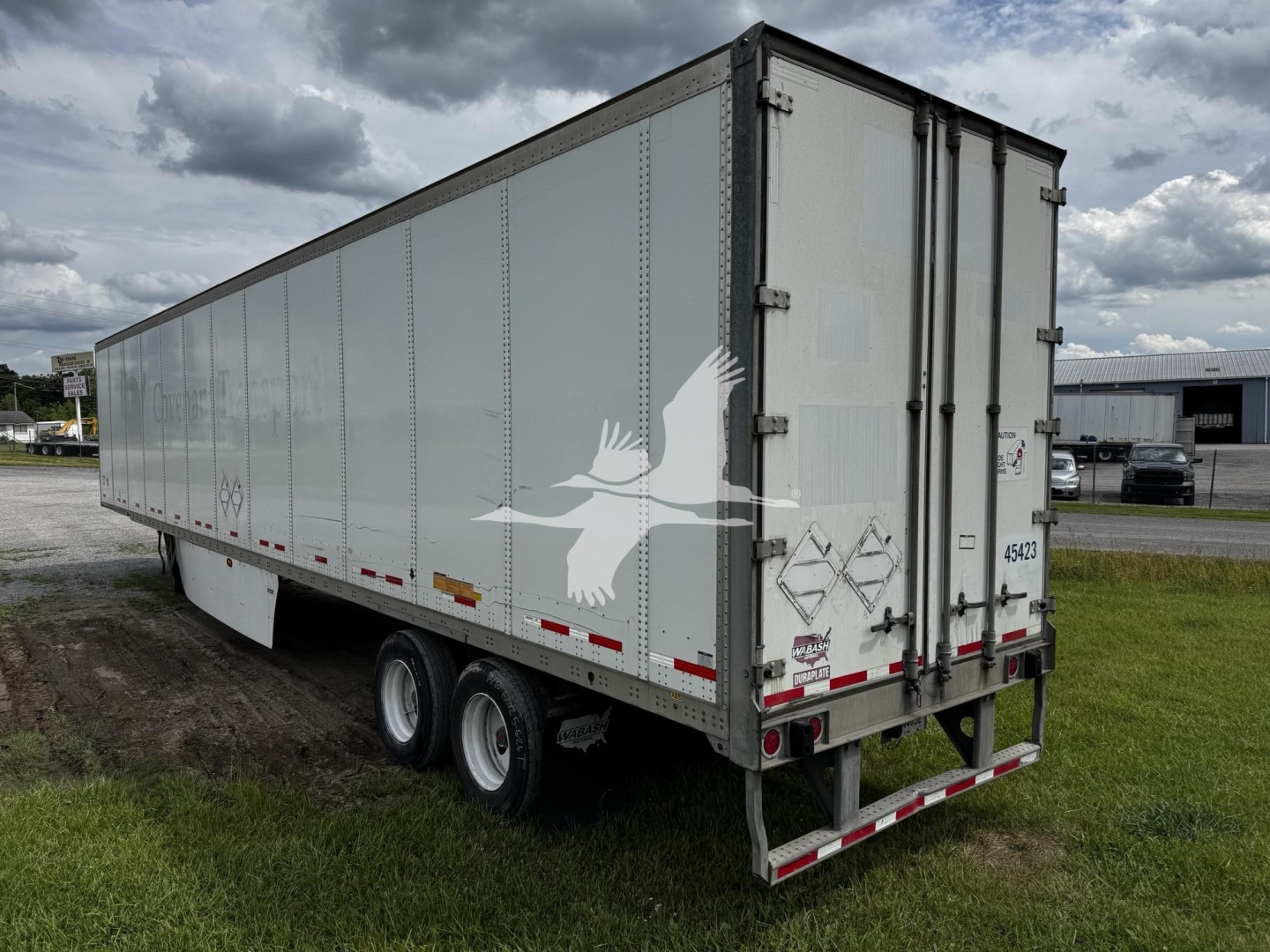 Trailer side view of a 2017 Wabash van trailer, tandem axle, long box with rear doors and reflective strips; stock 7705, VIN 1JJV532D3HL942036.