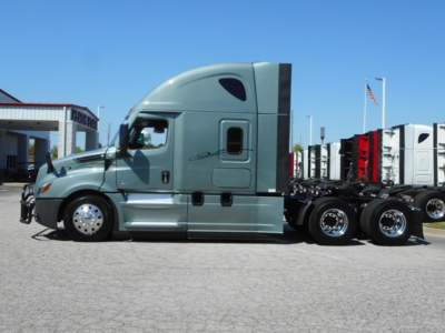 Truck side view of a 2023 Freightliner Cascadia 126 tractor with sleeper cab, long aerodynamic hood, dual rear axles, and chrome wheels.