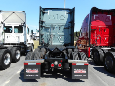 Truck chassis rear view showing trailer connection and mud flaps with Peach State Freightliners Jefferson, GA text.