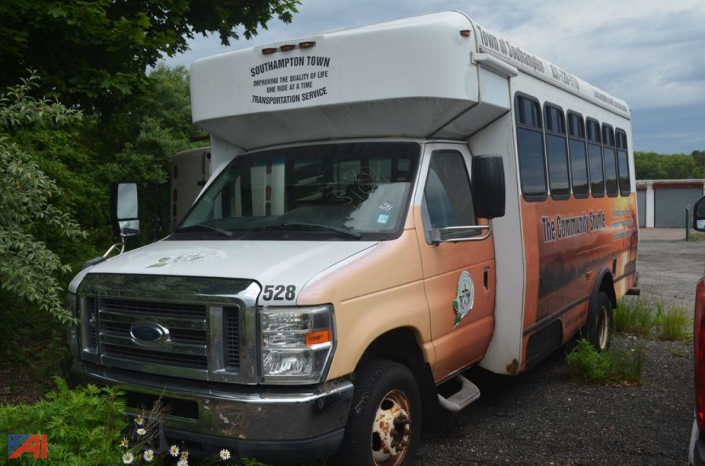 Ford E-450 shuttle bus with peach and white exterior, front chrome grille, side windows, and 'Southampton Town' markings on the roof edge.