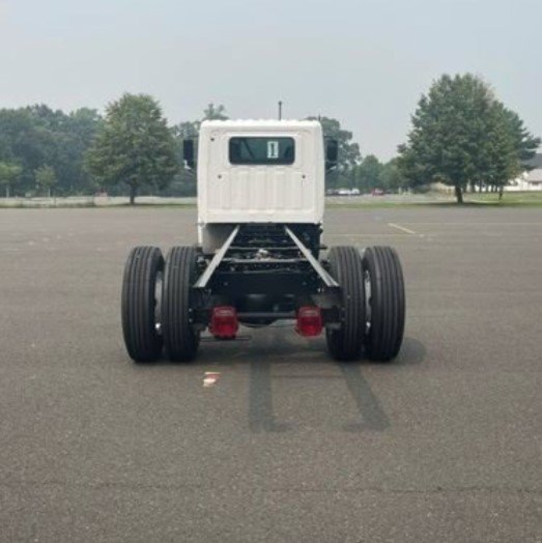 Chassis of a 2027 Hino L6 cab chassis truck viewed from rear showing dual rear axles and license plate area with a small cab.
