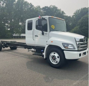 2027 Hino L6 cab chassis truck side view with white cab, dual rear wheels, and chassis exposed.