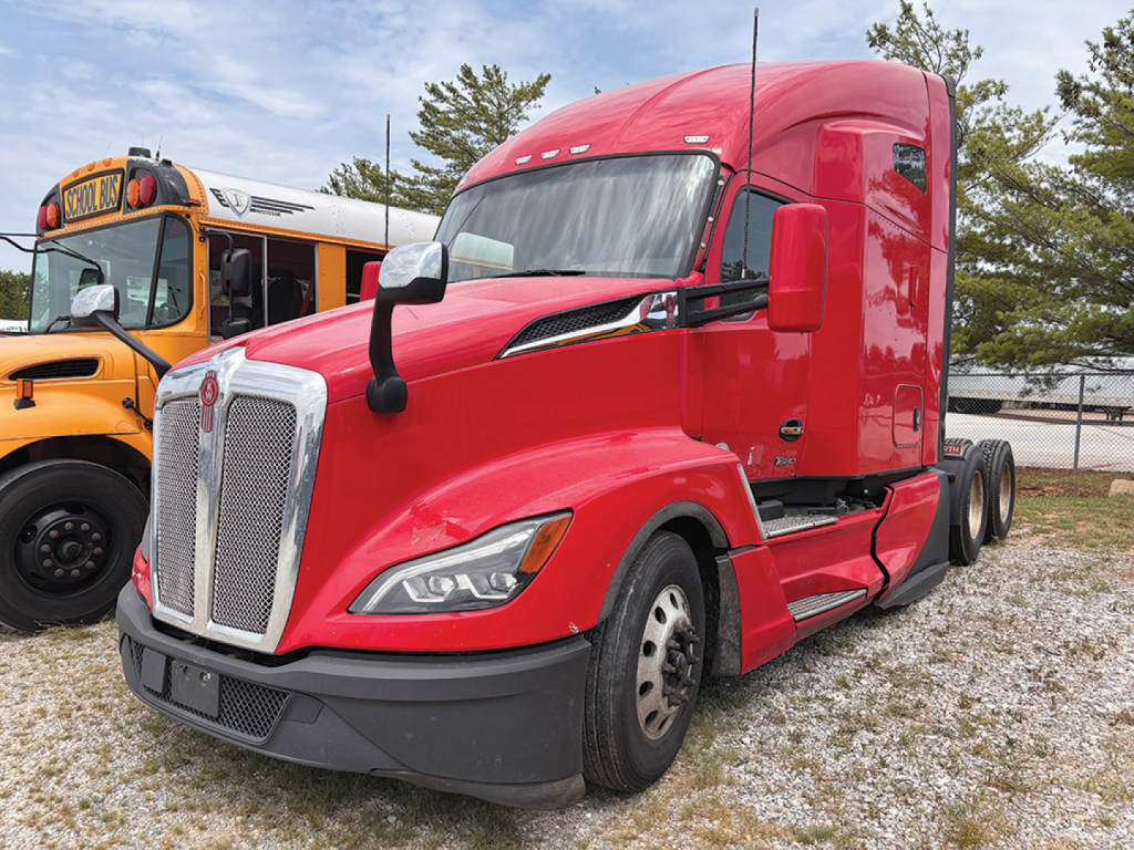 Kenworth T-680 Next Gen tractor in red, front-left view showing grille, headlights, and side mirrors.