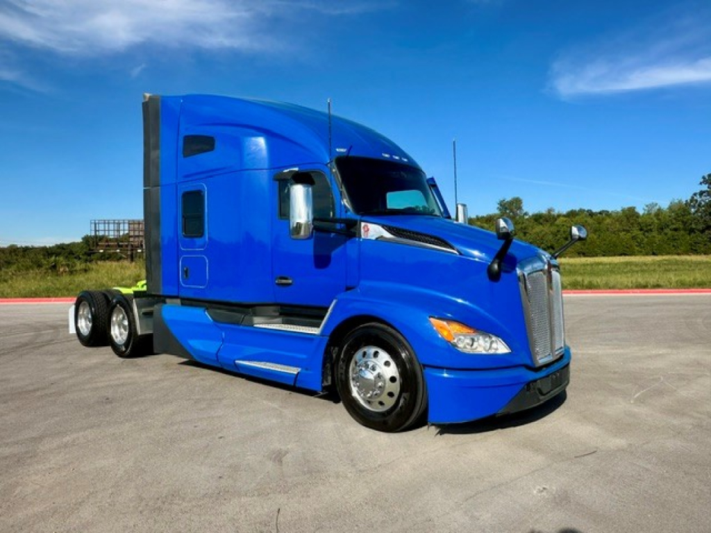 Kenworth T680 tractor in blue, side view showing aerodynamic cab and wheels.