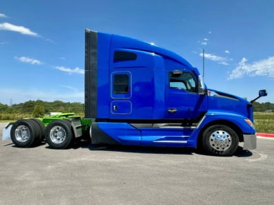 Kenworth T680 blue sleeper tractor side view showing cab profile and wheelset.