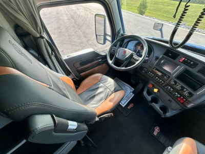 Kenworth T680 truck interior view showing steering wheel and dashboard with controls and seating