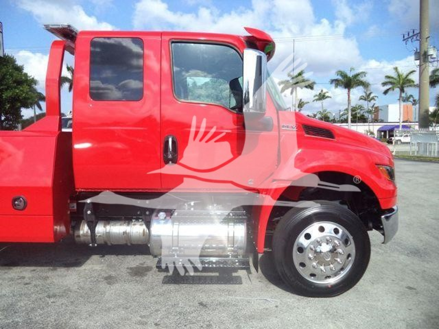 Red International MV truck side view showing cab and chrome fuel tank with wheel and tire, winch category labeling not visible in image.