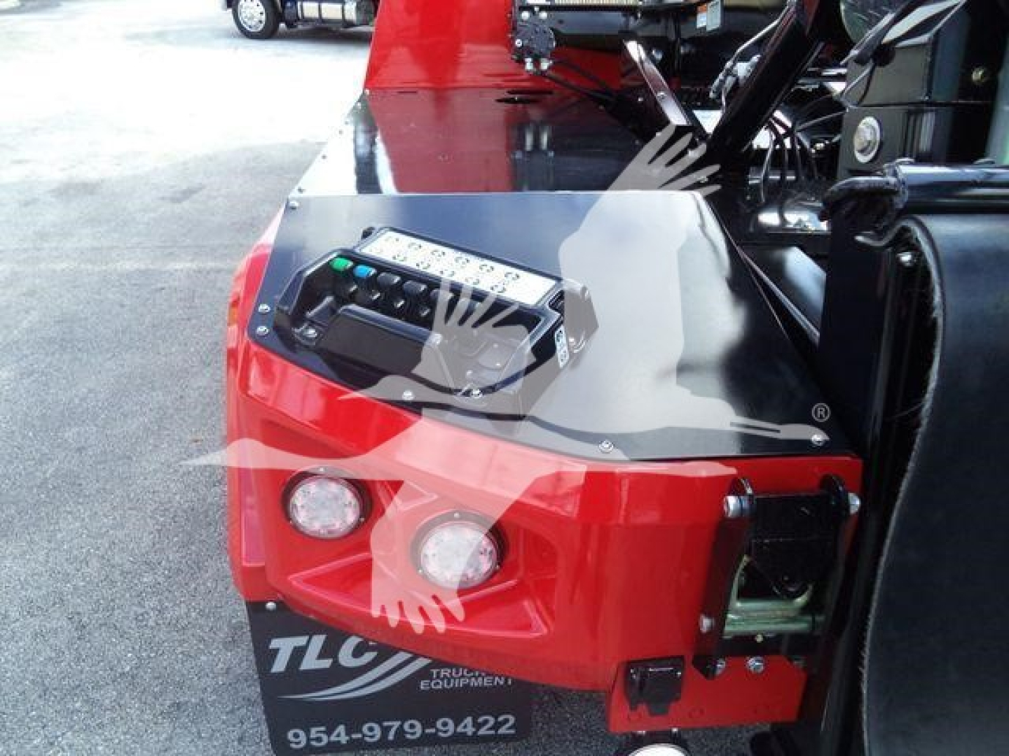 Winch-equipped front view of red International MV truck component with control panel and dual headlights.