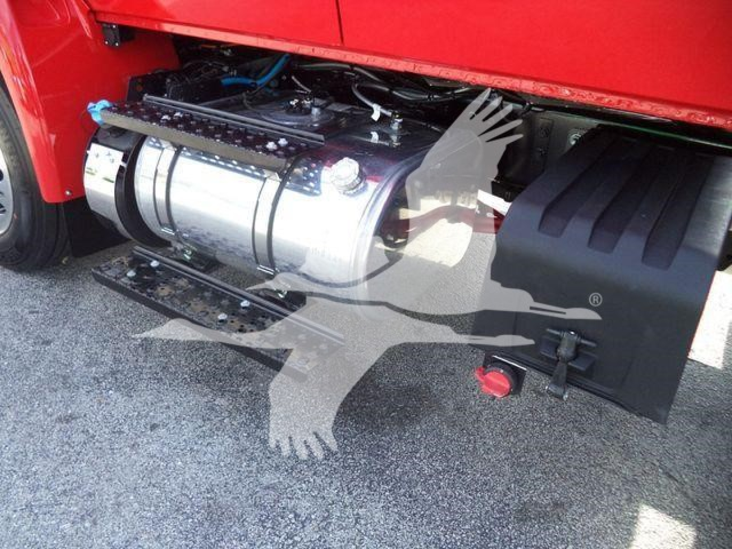 Winch-equipped 2025 International MV truck side view showing chrome fuel tank and winch assembly under cab