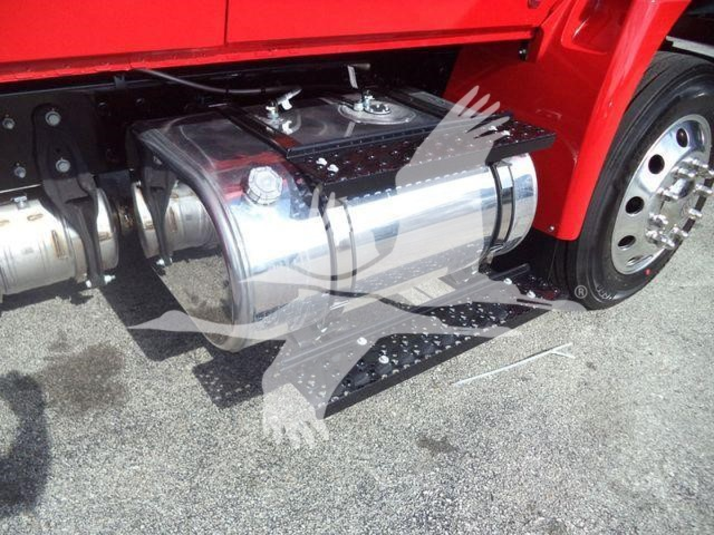Winch-equipped truck side view showing polished rectangular fuel/equipment tank under the cab and left front wheel.