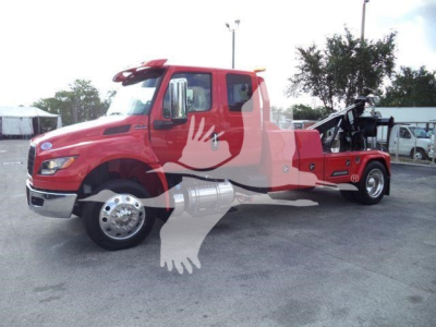 Truck cab and winch tow vehicle with red exterior and black tow arm, side view showing front wheel and cab door.